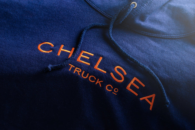 Stacked multi-colored Chelsea Truck Co Hoodie  On The Black Jeep 
