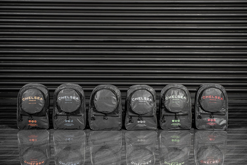 Wider View Of The Black Chelsea Truck Company Logo With The Reflective Backpack With The Zippers