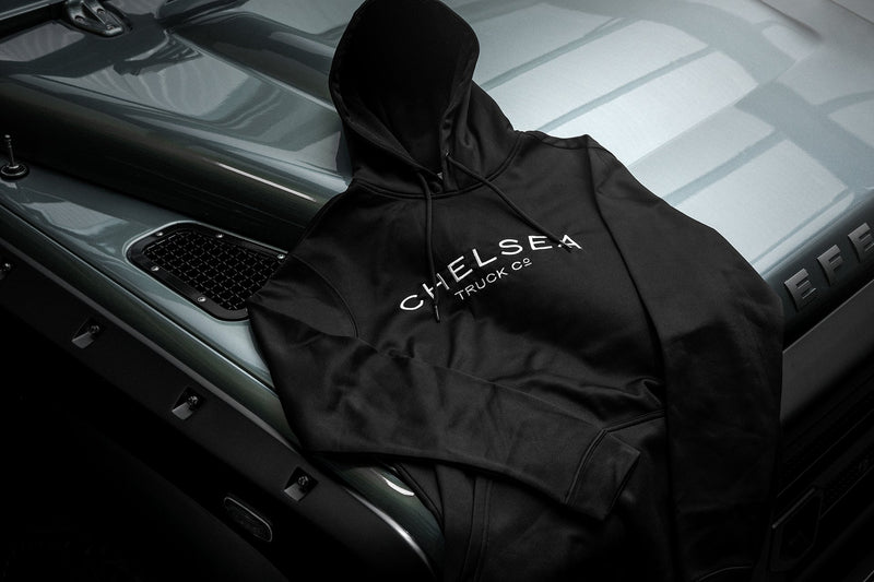 Men's Black with White Embroidery Chelsea Truck Co Hoodie On Gray Jeep 